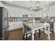 Modern kitchen featuring white cabinets, stainless steel appliances, and a granite island at 140 Southern Acres Dr, Fuquay Varina, NC 27526