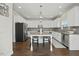 Modern kitchen featuring white cabinets, stainless steel appliances, and a granite island at 140 Southern Acres Dr, Fuquay Varina, NC 27526