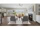 Open-concept living room with fireplace, built-ins, and hardwood floors at 140 Southern Acres Dr, Fuquay Varina, NC 27526