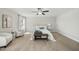Carpeted main bedroom featuring neutral color scheme, ceiling fan, and ample natural light at 140 Southern Acres Dr, Fuquay Varina, NC 27526