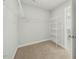 Unfurnished walk-in closet with carpeted floors and white shelving at 140 Southern Acres Dr, Fuquay Varina, NC 27526