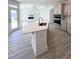 This kitchen is designed with a center island, stylish cabinetry, stainless appliances, and plenty of counter space at 142 Oban Dr, Homesite 135, Sanford, NC 27330