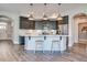 Kitchen features stainless steel appliances, gray cabinets, an island with pendant lights, and white countertop at 142 Oban Dr, Homesite 135, Sanford, NC 27330