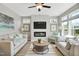 A bright living room features a fireplace, ceiling fan, and matching couches at 142 Oban Dr, Homesite 135, Sanford, NC 27330