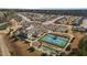 Birds eye view of a neighborhood showcasing tennis and bocce ball courts adjacent to the clubhouse at 1435 Monterey Bay Dr, Wake Forest, NC 27587