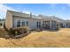 View of the backyard showing a tidy yard with a patio and screened in porch at 1435 Monterey Bay Dr, Wake Forest, NC 27587