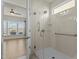Accessible bathroom with glass-enclosed shower featuring grab bars, and window at 1435 Monterey Bay Dr, Wake Forest, NC 27587