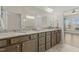 Bathroom vanity with granite countertop, double sinks, and view to shower and Primary bedroom at 1435 Monterey Bay Dr, Wake Forest, NC 27587