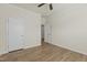 Simple bedroom featuring hardwood floors, two white doors, and neutral-colored walls at 1435 Monterey Bay Dr, Wake Forest, NC 27587