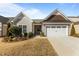 Charming single-story home boasts an attached two-car garage and well-maintained landscaping at 1435 Monterey Bay Dr, Wake Forest, NC 27587