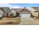 Charming single-story home features a two-car garage and inviting, landscaped front yard at 1435 Monterey Bay Dr, Wake Forest, NC 27587