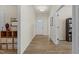 Inviting hallway featuring hardwood floors, a storage area, and a glimpse of the front door at 1435 Monterey Bay Dr, Wake Forest, NC 27587