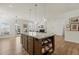 Kitchen with island, granite countertops, and pendant lighting with a view into the living room at 1435 Monterey Bay Dr, Wake Forest, NC 27587