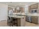Kitchen island with pendant lighting, stainless steel appliances, and granite countertops for a modern design at 1435 Monterey Bay Dr, Wake Forest, NC 27587
