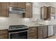 Close-up of a modern kitchen with stainless steel appliances and a granite countertop for stylish cooking at 1435 Monterey Bay Dr, Wake Forest, NC 27587