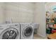 Functional laundry room with washer, dryer, utility sink, shelving, and walk-in storage area at 1435 Monterey Bay Dr, Wake Forest, NC 27587