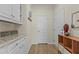 Functional mudroom with cabinets, granite countertops, and convenient access to a storage room at 1435 Monterey Bay Dr, Wake Forest, NC 27587