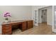 A cozy office space features a wooden desk and draws in a room with laminate wood flooring at 1435 Monterey Bay Dr, Wake Forest, NC 27587