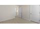 Bedroom with neutral carpet and two doors at 173 Paper Birch Way, Fuquay Varina, NC 27526