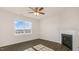 Bright room featuring luxury vinyl plank flooring, fireplace, large windows, and a ceiling fan at 173 Paper Birch Way, Fuquay Varina, NC 27526