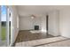 Open living space with luxury vinyl plank flooring, fireplace, sliding glass door, and natural light at 173 Paper Birch Way, Fuquay Varina, NC 27526