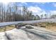 Backyard showcasing a cozy fire pit area with stone seating and a private fenced perimeter at 192 Springhill Ln, Garner, NC 27529