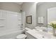 A clean, white bathroom with a shower-tub combination, white cabinets, and modern fixtures at 192 Springhill Ln, Garner, NC 27529