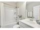 Bathroom with a combined tub and shower, vanity, neutral paint, and decorative mirror at 192 Springhill Ln, Garner, NC 27529