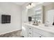 Bathroom with double sink vanity, tile floors, decorative mirror, and separate shower at 192 Springhill Ln, Garner, NC 27529