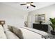 Bright bedroom featuring a ceiling fan, black dresser with gold accents, and a cozy, inviting bed at 192 Springhill Ln, Garner, NC 27529
