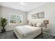 Bedroom with large window, neutral decor, and modern bedside tables at 192 Springhill Ln, Garner, NC 27529
