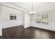 The dining room has dark wood floors, white wainscoting, and a modern light fixture at 192 Springhill Ln, Garner, NC 27529