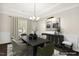 Elegant dining room features modern chandelier, sleek black buffet, and large window at 192 Springhill Ln, Garner, NC 27529