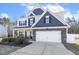 Traditional home with a two-car garage, blue and gray accents, and a welcoming front porch at 192 Springhill Ln, Garner, NC 27529