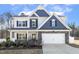 Charming two-story home featuring a stone-accented facade, white garage door, and well-manicured landscaping at 192 Springhill Ln, Garner, NC 27529