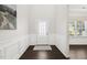 Light and bright foyer features a stylish front door, dark hardwood floors, and beautiful wainscoting at 192 Springhill Ln, Garner, NC 27529