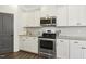 Modern kitchen features white cabinets, stainless steel appliances, and granite countertops at 192 Springhill Ln, Garner, NC 27529