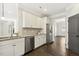 Bright kitchen with stainless steel appliances, white cabinets, and granite countertops at 192 Springhill Ln, Garner, NC 27529