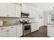 Modern kitchen with white cabinets, granite countertops, and stainless steel appliances at 192 Springhill Ln, Garner, NC 27529