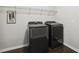 Laundry room with new black front loading washer and dryer at 192 Springhill Ln, Garner, NC 27529