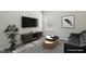 This staged living room features neutral decor, carpet, and a TV at 192 Springhill Ln, Garner, NC 27529