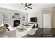 Cozy living room with fireplace, ceiling fan, and plush seating arrangement at 192 Springhill Ln, Garner, NC 27529