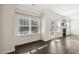 Bright and cozy living room with a fireplace, windows, and dark wood floors at 192 Springhill Ln, Garner, NC 27529