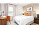 Stylish bedroom featuring a comfortable bed, patterned wallpaper, and a desk area by the window at 231 Perseus St, Angier, NC 27501