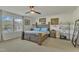 Comfortable bedroom featuring a wooden bed frame, neutral carpet, natural light from the window, and ceiling fan at 2437 Cedar Rock Dr, Wake Forest, NC 27587