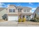 Inviting two-story home with a stone and siding exterior, a two-car garage, and well-maintained grounds at 2437 Cedar Rock Dr, Wake Forest, NC 27587