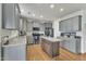 Eat-in kitchen with stainless steel appliances, an island, gray cabinets and granite countertops at 2437 Cedar Rock Dr, Wake Forest, NC 27587