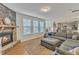 Bright, open living space with gray sectional sofa and views into the kitchen at 2437 Cedar Rock Dr, Wake Forest, NC 27587