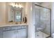This bathroom features a single sink vanity, well lit mirror, and a modern glass shower at 25 Blackhorn Ct, Pittsboro, NC 27312