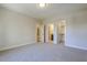 Spacious carpeted bedroom featuring multiple doorways to bathroom and closet at 25 Blackhorn Ct, Pittsboro, NC 27312